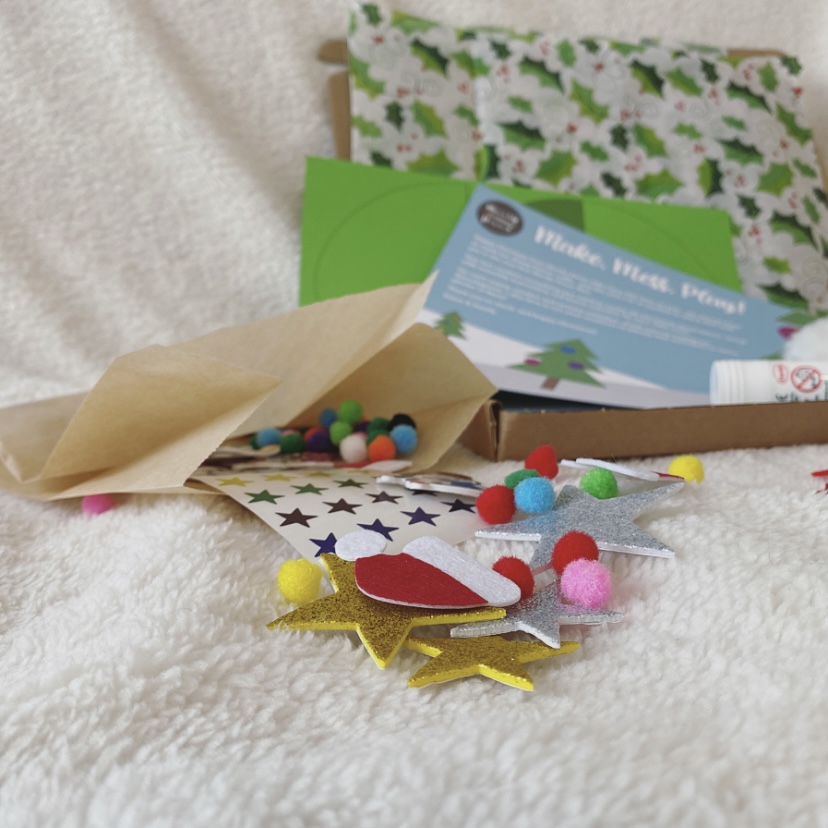 Selection of Stickers and pom-poms from Christmas Craft Box including Santa hats and stars